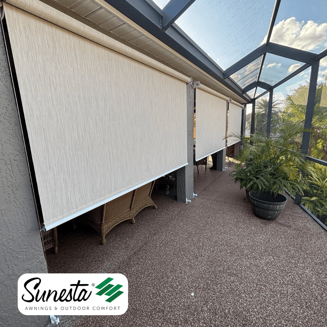 Sunesta retractable shade screens installed on a patio enclosure with skylight panels, providing sun protection over seating area with potted plants visible